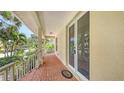 Covered patio with brick flooring, offers a charming view of the surrounding greenery at 205 Sugarloaf Dr, Nokomis, FL 34275