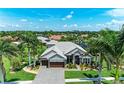 A lovely single-story home with a well-manicured lawn and mature palm trees at 303 Cockle Shell Loop, Apollo Beach, FL 33572