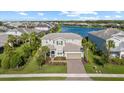 Stunning aerial view of a well-maintained home situated on a lot with a lake view at 3344 Anchor Bay Trl, Bradenton, FL 34211