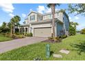 Beautifully landscaped home with a brick driveway and a two-car garage, set against a blue sky at 3344 Anchor Bay Trl, Bradenton, FL 34211