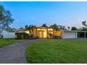 Charming one-story home featuring a circular driveway, a covered carport and landscaped yard at 355 Shore Dr, Ellenton, FL 34222