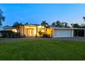 Charming home exterior featuring a well-manicured lawn, covered entrance, and attached garage, perfect for suburban living at 355 Shore Dr, Ellenton, FL 34222