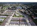 Aerial view showcases this home's location in a well-planned community with lake and nearby golf course at 3681 Divot Ln, Sarasota, FL 34232