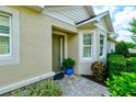 Inviting front entrance featuring a stylish door, plants, and a paved walkway at 3681 Divot Ln, Sarasota, FL 34232