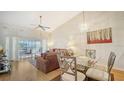 Cozy living room featuring hardwood floors and sliding glass doors to the lanai at 4211 Caddie E Dr # 202, Bradenton, FL 34203