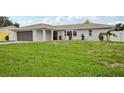 Well-maintained single-story home with a lush lawn and an attached garage at 4344 Bent Tree Blvd, Sarasota, FL 34241