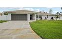 Beautiful single-story home with a well-maintained lawn and gray garage door at 4344 Bent Tree Blvd, Sarasota, FL 34241