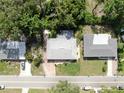 An aerial view shows the home's location in a serene neighborhood with mature trees at 4455 Emerald Ridge Dr, Sarasota, FL 34233