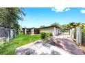 A spacious, grassy backyard with a secure fence, perfect for outdoor activities at 4455 Emerald Ridge Dr, Sarasota, FL 34233