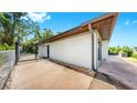 Side view shows a fenced yard and modern exterior with a gated entrance at 4455 Emerald Ridge Dr, Sarasota, FL 34233