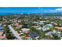 An aerial view showcases this home's location with views of the intercoastal waterway at 483 Partridge Cir, Sarasota, FL 34236