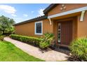 Home exterior showcasing brick walkway and well-maintained landscaping at 5121 Serata Dr, Lakewood Ranch, FL 34211