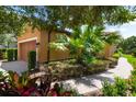 Manicured landscaping with a brick pathway and a peek at the garage at 5121 Serata Dr, Lakewood Ranch, FL 34211