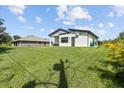Expansive backyard featuring verdant lawn and stylish modern home at 5339 Gulfport Ter, Port Charlotte, FL 33981