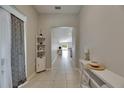 Bright foyer with tile flooring, elegant console table, leading to open living spaces at 5521 Olano St, Palmetto, FL 34221