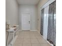 Bright foyer with tile flooring, elegant console table, and decorative curtains at 5521 Olano St, Palmetto, FL 34221