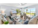 Bright living room with beach views, comfortable seating, and coastal decor at 6312 Midnight Pass Rd # 102S, Sarasota, FL 34242