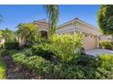Inviting home with lush landscaping, decorative shutters, and a neutral color palette at 7419 Birds Eye Ter, Bradenton, FL 34203
