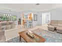 Open-concept living room and dining area with lots of natural light and seamless access to the kitchen at 760 Azure Rd, Venice, FL 34293