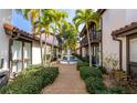 Picturesque courtyard featuring a fountain, palm trees, and lush landscaping that adds to the tranquility of the condos at 800 S Blvd Of The Presidents # 16, Sarasota, FL 34236
