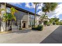 Beautiful exterior showing the building design with palm trees enhancing curb appeal, complemented by a well-maintained driveway at 800 S Blvd Of The Presidents # 16, Sarasota, FL 34236