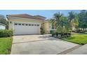 Inviting home with an attached garage, well-manicured lawn, and mature landscaping at 8183 Nice Way, Sarasota, FL 34238