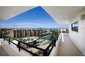 Balcony view overlooking lush amenities and ocean views from this condo complex at 8735 Midnight Pass Rd # 602B, Sarasota, FL 34242