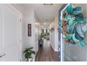 Inviting entryway with wood-look flooring, a welcome sign, and a view of the living area at 8985 Royal River Cir, Parrish, FL 34219