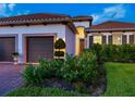Close-up of the exterior showcasing a well-manicured lawn and decorative front garden at 10120 Carnoustie Pl, Bradenton, FL 34211