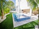 Backyard with outdoor pool, spa, lush landscaping, and covered outdoor dining space at 111 6Th N St, Bradenton Beach, FL 34217