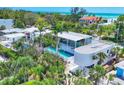 Stunning aerial view of the home with a sparkling pool and lush tropical landscaping at 1168 Westway Dr, Sarasota, FL 34236