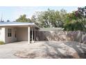 A spacious driveway leads to a wooden privacy fence next to the carport of this lovely home at 1207 65Th Nw St, Bradenton, FL 34209