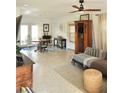 Sunlit living room featuring stylish furniture, ceiling fan, and views to dining area via french doors at 1207 65Th Nw St, Bradenton, FL 34209