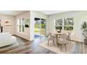 Bright dining area featuring modern furnishings and sliding glass doors leading to outdoor space at 12071 Mountain Island Trl, Parrish, FL 34219