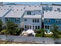 Aerial view of a backyard featuring a patio with outdoor seating, a grill, and well-maintained landscaping at 2217 Muesel St, Sarasota, FL 34237