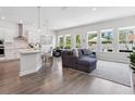 Bright open-concept living space with hardwood floors, modern furnishings, and abundant natural light at 2217 Muesel St, Sarasota, FL 34237