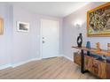 Inviting condo entryway with hardwood floors, modern decor, and a stylish console table at 2295 Gulf Of Mexico Dr # 64S, Longboat Key, FL 34228