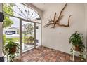 Welcoming foyer with brick flooring, ornamental accents, and views to the outside at 2381 Appaloosa Cir, Sarasota, FL 34240