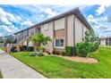 Exterior view of a two-story condo building with lush green lawn at 25100 Sandhill Blvd # 104 G, Punta Gorda, FL 33983