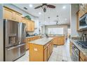 Well-equipped kitchen featuring granite countertops, stainless steel appliances, and a center island at 3041 Stonegate Falls Dr, Land O Lakes, FL 34638