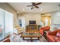 Inviting living room with hardwood floors, comfortable seating, and a cozy fireplace at 3041 Stonegate Falls Dr, Land O Lakes, FL 34638