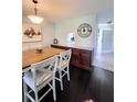 Elegant dining room with dark floors, dining table, and chairs; flows into living spaces at 3305 Notre Dame Pl # 3305, Bradenton, FL 34207