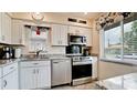 Bright kitchen featuring white cabinets, stainless steel appliances, and a charming window view at 3305 Notre Dame Pl # 3305, Bradenton, FL 34207