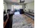 Spacious living room with plush seating, dark wood floors, and lots of natural light at 3305 Notre Dame Pl # 3305, Bradenton, FL 34207