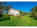 Spacious villa with well-maintained lawn and mature landscaping on a bright, sunny day at 4279 Oakhurst E Cir # 3044, Sarasota, FL 34233