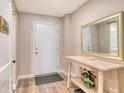 Welcoming entryway featuring a console table, mirror, and a charming floral arrangement at 4325 Gulf Of Mexico Dr # 204, Longboat Key, FL 34228