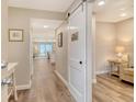 Inviting hallway featuring hardwood floors, a stylish sliding door, and serene ocean views at 4325 Gulf Of Mexico Dr # 204, Longboat Key, FL 34228