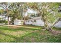 Charming home featuring a detached garage, white siding, and mature trees in a well-maintained yard at 520 27Th W St, Bradenton, FL 34205
