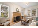 Bright living room features a stone fireplace, neutral decor, and plenty of natural light at 520 27Th W St, Bradenton, FL 34205