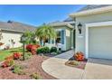 Beautiful single-story home with lush landscaping, palm trees, and a well-manicured lawn at 5333 Tide Point Way, Bradenton, FL 34208